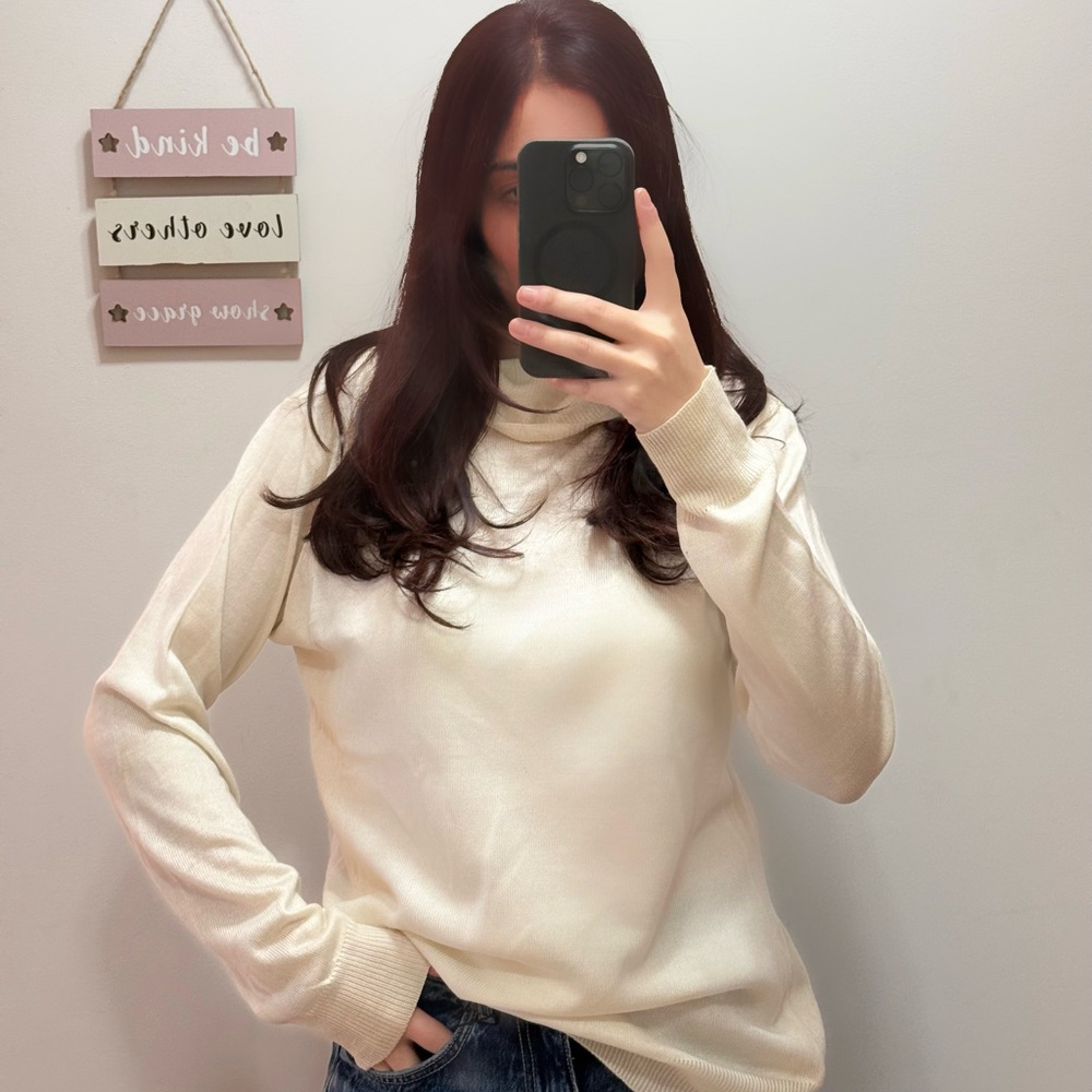 White-creamish turtleneck. Relaxed fit for any occasion.